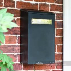 Large "Pevensey Square” Newspaper And Parcel Holder -Garden Supply Discount Store black and brass newspaper box on brick wall